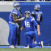 Detroit Lions running back Craig Reynolds (13) helps quarterback Jared Goff (16) up against the Washington Commanders during the first half of an NFL football divisional playoff game, Saturday, Jan. 18, 2025, in Detroit. (AP Photo/Mike Mulholland)