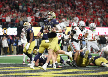 ATLANTA, GEORGIA - JANUARY 20: Riley Leonard #13 of the Notre Dame Fighting Irish scores a first quarter touchdown against the Ohio State Buckeyes during the 2025 CFP National Championship at the Mercedes-Benz Stadium on January 20, 2025 in Atlanta, Georgia. (Photo by Jamie Squire/Getty Images)