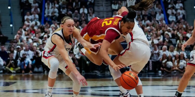 JuJu Watkins, center, is defended by Paige Bueckers and Kaitlyn Chen during the second half of an NCAA women's basketball game at the XL Center on Dec. 21, 2024 in Hartford, Connecticut.