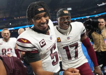 Jayden Daniels #5 of the Washington Commanders celebrates with Terry McLaurin #17 after defeating the Detroit Lions 45-31 in the NFC Divisional Playoff at Ford Field on January 18, 2025 in Detroit, Michigan.  