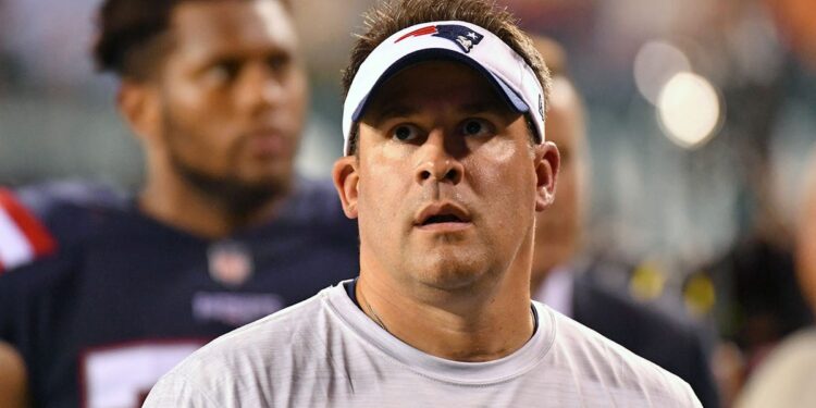 Josh McDaniels looks up on field