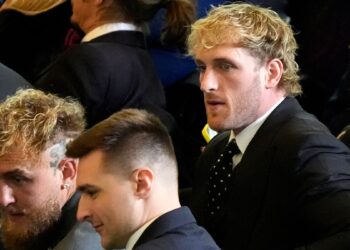 Jake and Logan Paul look to their left inside Emancipation Hall