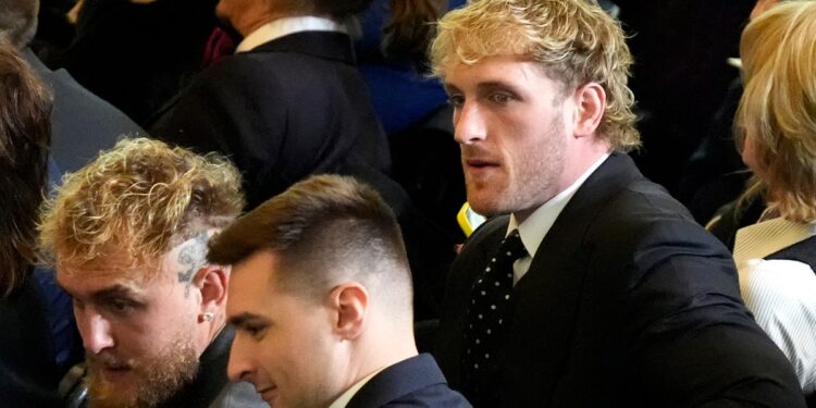 Jake and Logan Paul look to their left inside Emancipation Hall