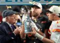 Travis Kelce and Patrick Mahomes pass the trophy