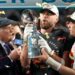 Travis Kelce and Patrick Mahomes pass the trophy