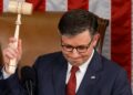 House Speaker Mike Johnson holds up gavel