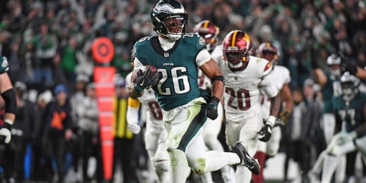 Nov 14, 2024; Philadelphia, Pennsylvania, USA; Philadelphia Eagles running back Saquon Barkley (26) runs past Washington Commanders defenders on way to a 39-yard touchdown during the fourth quarter against the Washington Commanders at Lincoln Financial Field. 