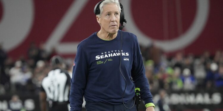 Pete Carroll looks on