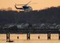 A US Park Police helicopter flies over the Potomac River