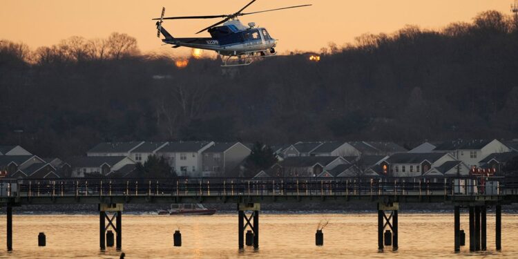 A US Park Police helicopter flies over the Potomac River