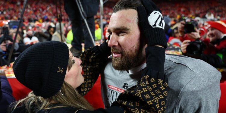 Taylor Swift and Travis Kelce celebrate on field