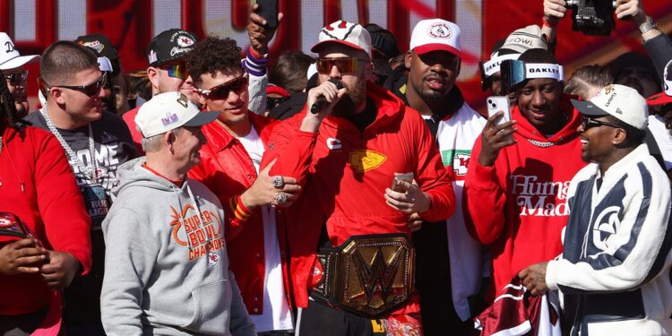 Travis Kelce and his teammates, including Patrick Mahomes celebrate during the Super Bowl Parade 2024