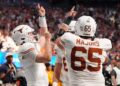 Texas Longhorns quarterback Quinn Ewers (3) celebrates with teammates after scoring a touchdown against the Arizona State Sun Devils during the second half of the Peach Bowl at Mercedes-Benz Stadium. 