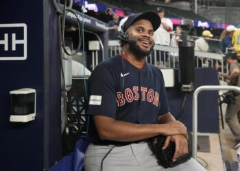 Boston Red Sox relief pitcher Kenley Jansen smiles as he does a radio interview after the team's win in a baseball game against the Atlanta Braves on Wednesday, May 10, 2023, in Atlanta. Jansen notched his 400th career save. (AP Photo/John Bazemore)