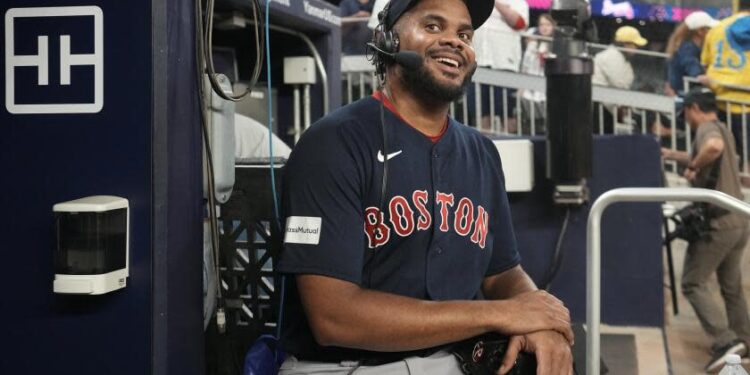 Boston Red Sox relief pitcher Kenley Jansen smiles as he does a radio interview after the team's win in a baseball game against the Atlanta Braves on Wednesday, May 10, 2023, in Atlanta. Jansen notched his 400th career save. (AP Photo/John Bazemore)