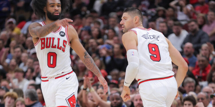 CHICAGO, IL - OCTOBER 30: Chicago Bulls guard Coby White (0) and Chicago Bulls center Nikola Vucevic (9)  during the second half against the Orlando Magic on October 30, 2024 at the United Center in Chicago, Illinois. (Photo by Melissa Tamez/Icon Sportswire via Getty Images)