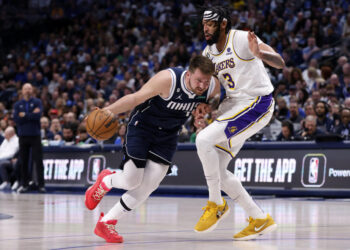 DALLAS, TX - FEBRUARY 26: Luka Doncic #77 of the Dallas Mavericks handles the ball against Anthony Davis #3 of the Los Angeles Lakers in the first half of the game at American Airlines Center on February 26, 2023 in Dallas, Texas. NOTE TO USER: User expressly acknowledges and agrees that, by downloading and or using this photograph, User is consenting to the terms and conditions of the Getty Images License Agreement. (Photo by Ron Jenkins/Getty Images)