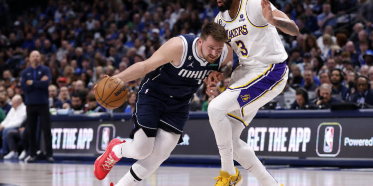 DALLAS, TX - FEBRUARY 26: Luka Doncic #77 of the Dallas Mavericks handles the ball against Anthony Davis #3 of the Los Angeles Lakers in the first half of the game at American Airlines Center on February 26, 2023 in Dallas, Texas. NOTE TO USER: User expressly acknowledges and agrees that, by downloading and or using this photograph, User is consenting to the terms and conditions of the Getty Images License Agreement. (Photo by Ron Jenkins/Getty Images)