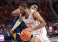 Jan 15, 2025; Houston, Texas, USA; Houston Cougars forward J'Wan Roberts (13) dribbles against West Virginia Mountaineers forward Amani Hansberry (13) in the first half at Fertitta Center. Mandatory Credit: Thomas Shea-Imagn Images