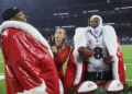 Baltimore Ravens quarterback Lamar Jackson (8) and running back Derrick Henry (22) wear Santa coats while being interviewed by Netflix host Jamie Erdahl after the game against the Houston Texans at NRG Stadium. Mandatory Credit: Troy Taormina-Imagn Images