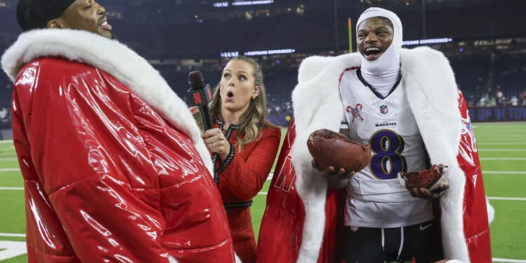 Baltimore Ravens quarterback Lamar Jackson (8) and running back Derrick Henry (22) wear Santa coats while being interviewed by Netflix host Jamie Erdahl after the game against the Houston Texans at NRG Stadium. Mandatory Credit: Troy Taormina-Imagn Images