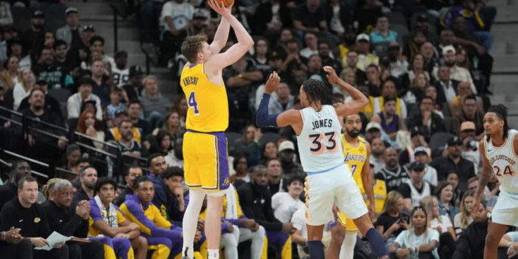 Nov 27, 2024; San Antonio, Texas, USA; Los Angeles Lakers guard Dalton Knecht (4) shoots over San Antonio Spurs guard Tre Jones (33) in the first half at Frost Bank Center. Mandatory Credit: Daniel Dunn-Imagn Images