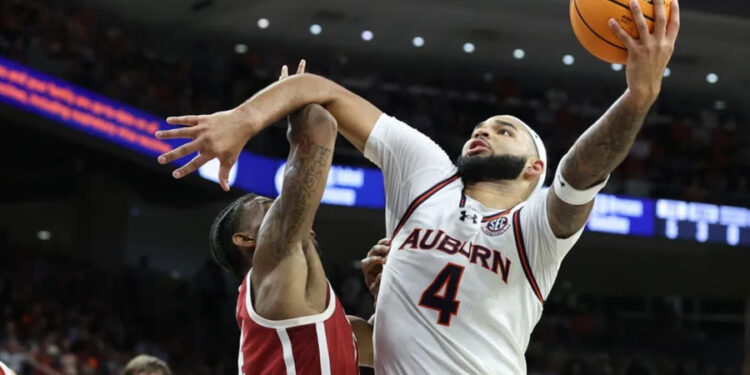 Feb 4, 2025; Auburn, Alabama, USA; Auburn Tigers forward Johni Broome (4) takes a shot over Oklahoma Sooners forward Jalon Moore (14) during the second half at Neville Arena. Mandatory Credit: John Reed-Imagn Images