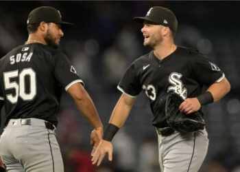 Sep 16, 2024; Anaheim, California, USA; Chicago White Sox left fielder Andrew Benintendi (23) and second baseman Lenyn Sosa (50) head off the field after the final out of the ninth inning defeating the Los Angeles Angels at Angel Stadium. Mandatory Credit: Jayne Kamin-Oncea-Imagn Images