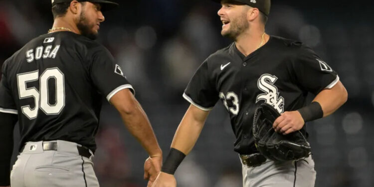 Sep 16, 2024; Anaheim, California, USA; Chicago White Sox left fielder Andrew Benintendi (23) and second baseman Lenyn Sosa (50) head off the field after the final out of the ninth inning defeating the Los Angeles Angels at Angel Stadium. Mandatory Credit: Jayne Kamin-Oncea-Imagn Images