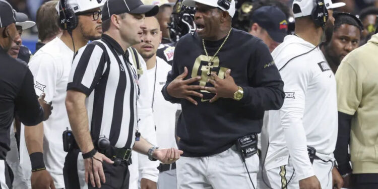 Dec 28, 2024; San Antonio, TX, USA; Colorado Buffaloes head coach Deion Sanders reacts with an official after a play during the second quarter against the Brigham Young Cougars at Alamodome. Mandatory Credit: Troy Taormina-Imagn Images