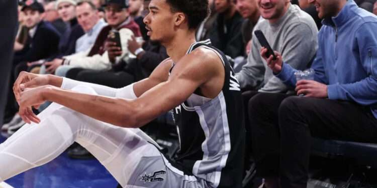 Dec 25, 2024; New York, New York, USA; San Antonio Spurs center Victor Wembanyama (1) sits on the floor after getting fouled in the third quarter against the New York Knicks at Madison Square Garden. Mandatory Credit: Wendell Cruz-Imagn Images