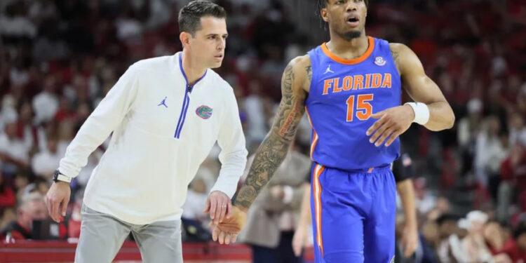 Jan 11, 2025; Fayetteville, Arkansas, USA; Florida Gators head coach Todd Golden talks to guard Alijah Martin (15) during the second half against the Arkansas Razorbacks at Bud Walton Arena. Mandatory Credit: Nelson Chenault-Imagn Images