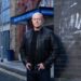 Ross Kemp in character on the EastEnders set, with Walford East Station behind him