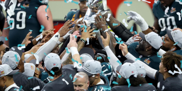 Eagles players hoist the Lombardi Trophy. (Chris Graythen/Getty Images)