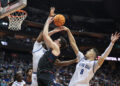 Feb 15, 2025; Newark, New Jersey, USA; Connecticut Huskies forward Alex Karaban (11) goes to the basket asSeton Hall Pirates forward Yacine Toumi (9) defends during the first half at Prudential Center. Mandatory Credit: Vincent Carchietta-Imagn Images