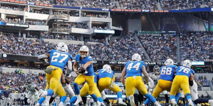 INGLEWOOD, CA - NOVEMBER 10: Los Angeles Chargers quarterback Justin Herbert (10) hands off to Los Angeles Chargers running back J.K. Dobbins (27) during the Tennessee Titans vs Los Angeles Chargers game on November 10, 2024, at SoFi Stadium in Inglewood, CA. (Photo by Jevone Moore/Icon Sportswire via Getty Images)