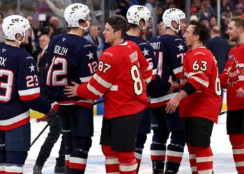 Team USA and Canada shake hands