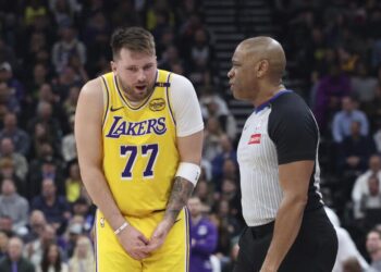 Los Angeles Lakers guard Luka Doncic (77) speaks with referee Tre Maddox (23) about a foul during the second quarter of an NBA basketball game against the Utah Jazz, Wednesday, Feb. 12, 2025, in Salt Lake City. (AP Photo/Rob Gray)