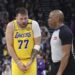 Los Angeles Lakers guard Luka Doncic (77) speaks with referee Tre Maddox (23) about a foul during the second quarter of an NBA basketball game against the Utah Jazz, Wednesday, Feb. 12, 2025, in Salt Lake City. (AP Photo/Rob Gray)