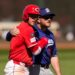 Cincinnati Reds' Gavin Lux, left, hugs Los Angeles Dodgers third baseman Max Muncy.