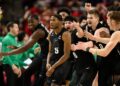 Michigan State guard Tre Holloman (5) and teammates celebrate after he made a game-winning basket to win the game at the buzzer during the second half of an NCAA college basketball game against Maryland, Wednesday, Feb. 26, 2025, in College Park, Md. (AP Photo/Nick Wass)