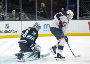 Jan 31, 2025; Salt Lake City, Utah, USA;  Columbus Blue Jackets left wing James van Riemsdyk (21) tries to deflect the puck past Utah Hockey Club goaltender Karel Vejmelka (70) and into the net with his skate during the third period at Delta Center. Mandatory Credit: Chris Nicoll-Imagn Images