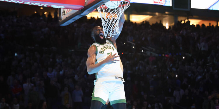 INDIANAPOLIS, INDIANA - FEBRUARY 17: Jaylen Brown #7 of the Boston Celtics dunks the ball over Donovan Mitchell #45 of the Cleveland Cavaliers in the 2024 AT&T Slam Dunk contest during the State Farm All-Star Saturday Night at Lucas Oil Stadium on February 17, 2024 in Indianapolis, Indiana. NOTE TO USER: User expressly acknowledges and agrees that, by downloading and or using this photograph, User is consenting to the terms and conditions of the Getty Images License Agreement. (Photo by Stacy Revere/Getty Images)