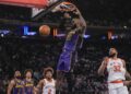 Lakers star LeBron James dunks in front of New York's Karl-Anthony Towns at Madison Square Garden.