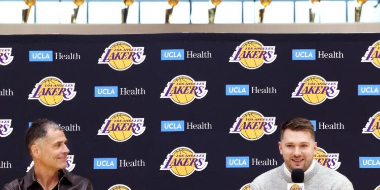 EL SEGUNDO, CA, FEBRUARY 4, 2025: General Manager Rob Pelinka, left, introduces new Lakers player Luka Doncic, right, at the Lakers training facility in El Segundo on Tuesday, February 4, 2025. (Christina House / Los Angeles Times)