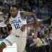 UCLA guard Sebastian Mack (12) dribbles against Michigan State guard Jase Richardson (11) during the second half of an NCAA college basketball game in Los Angeles, Tuesday, Feb. 4, 2025. (AP Photo/Eric Thayer)