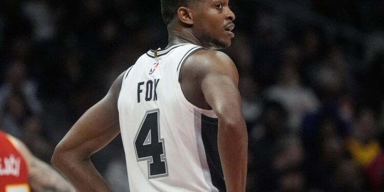 San Antonio Spurs De'Aaron Fox (4) moves on court against the Atlanta Hawks during the second half of an NBA basketball game, Wednesday, Feb. 5, 2025, in Atlanta. (AP Photo/Mike Stewart)