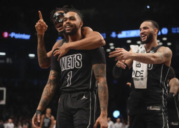 Brooklyn Nets' D'Angelo Russell (1) celebrates with teamamtes after making a three-point shot during the second half of an NBA basketball game against the Houston Rockets Tuesday, Feb. 4, 2025, in New York. (AP Photo/Frank Franklin II)