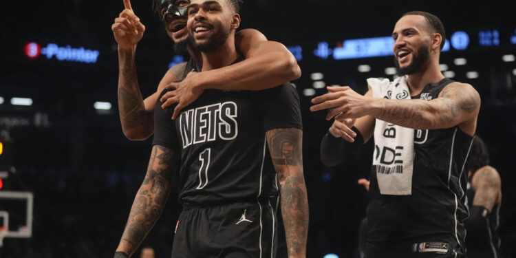 Brooklyn Nets' D'Angelo Russell (1) celebrates with teamamtes after making a three-point shot during the second half of an NBA basketball game against the Houston Rockets Tuesday, Feb. 4, 2025, in New York. (AP Photo/Frank Franklin II)