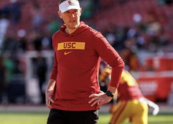 USC coach Lincoln Riley watches his team warm up before playing Notre Dame